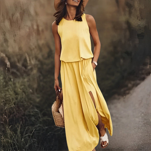 Woman in a yellow dress walking on a path with a blurred natural background