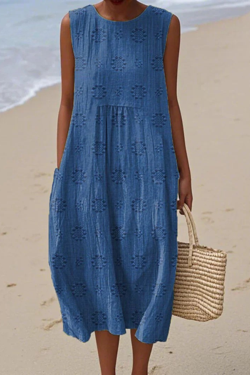Woman wearing a blue dress on a beach