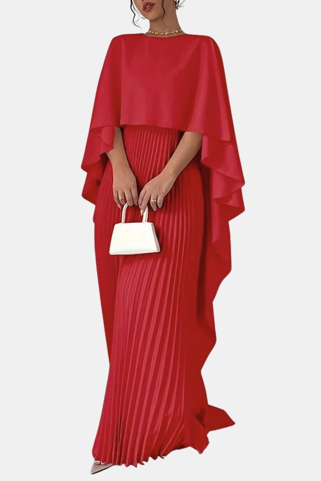 Red pleated dress with a cape held by a person on a white background