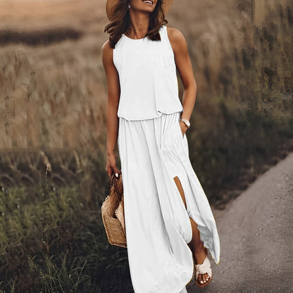 Woman in a white sleeveless top and long skirt walking on a path with a straw hat and basket.