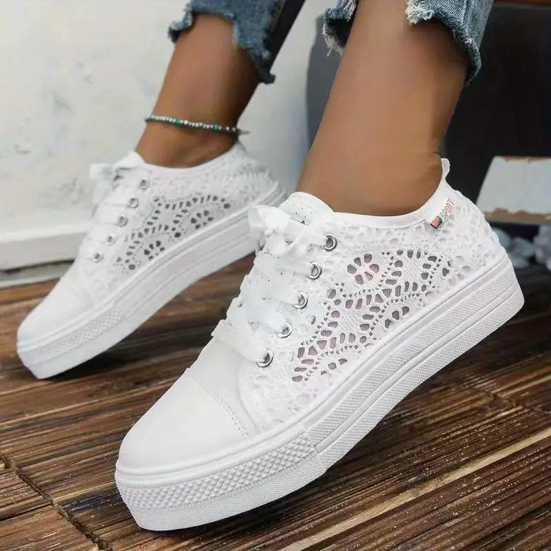 White lace-up sneakers on a wooden floor