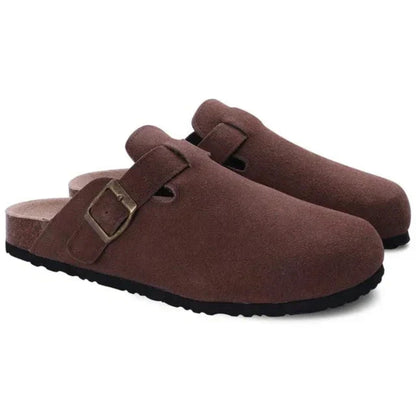 Pair of brown suede clogs with a buckle on a white background