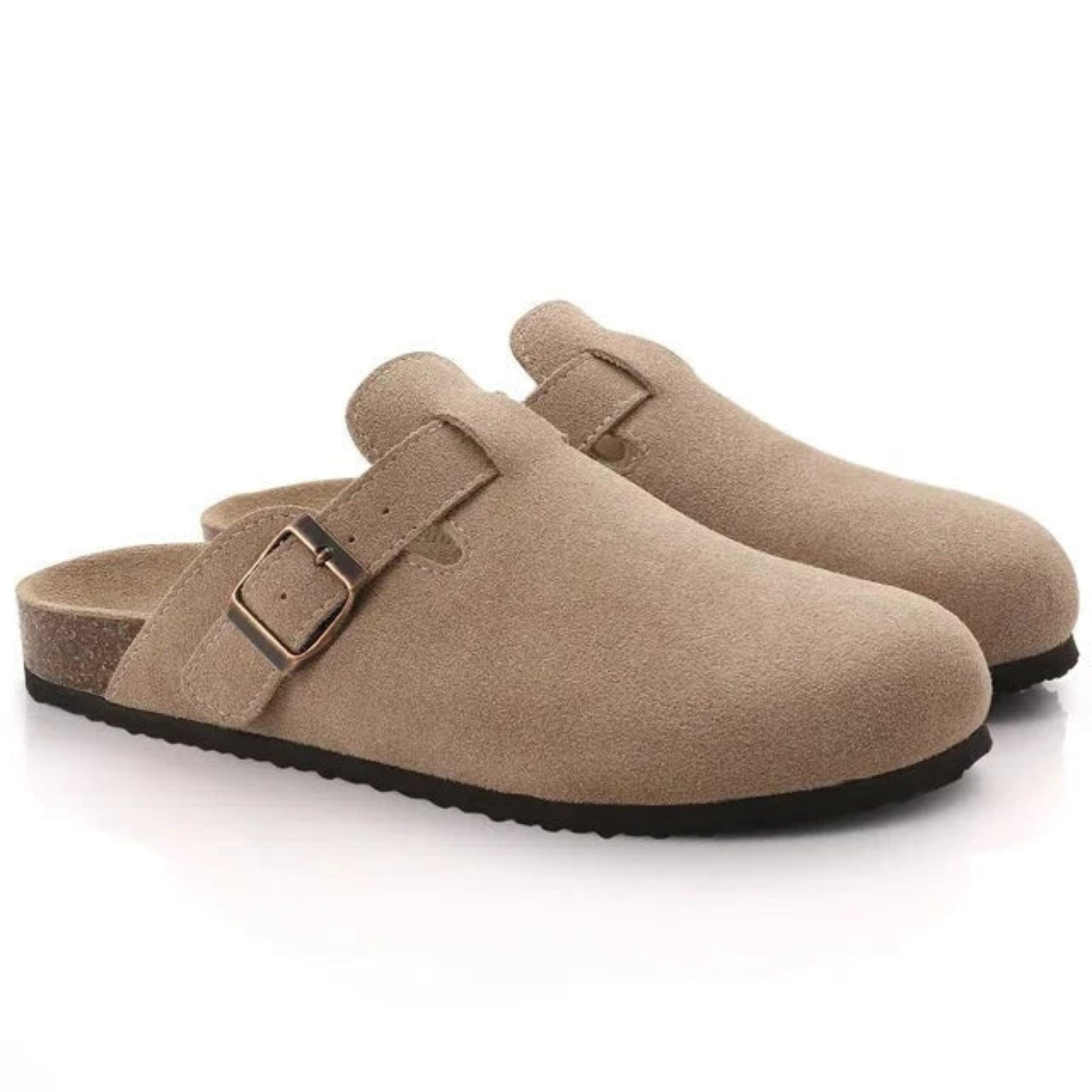Pair of beige clogs with a buckle on a white background