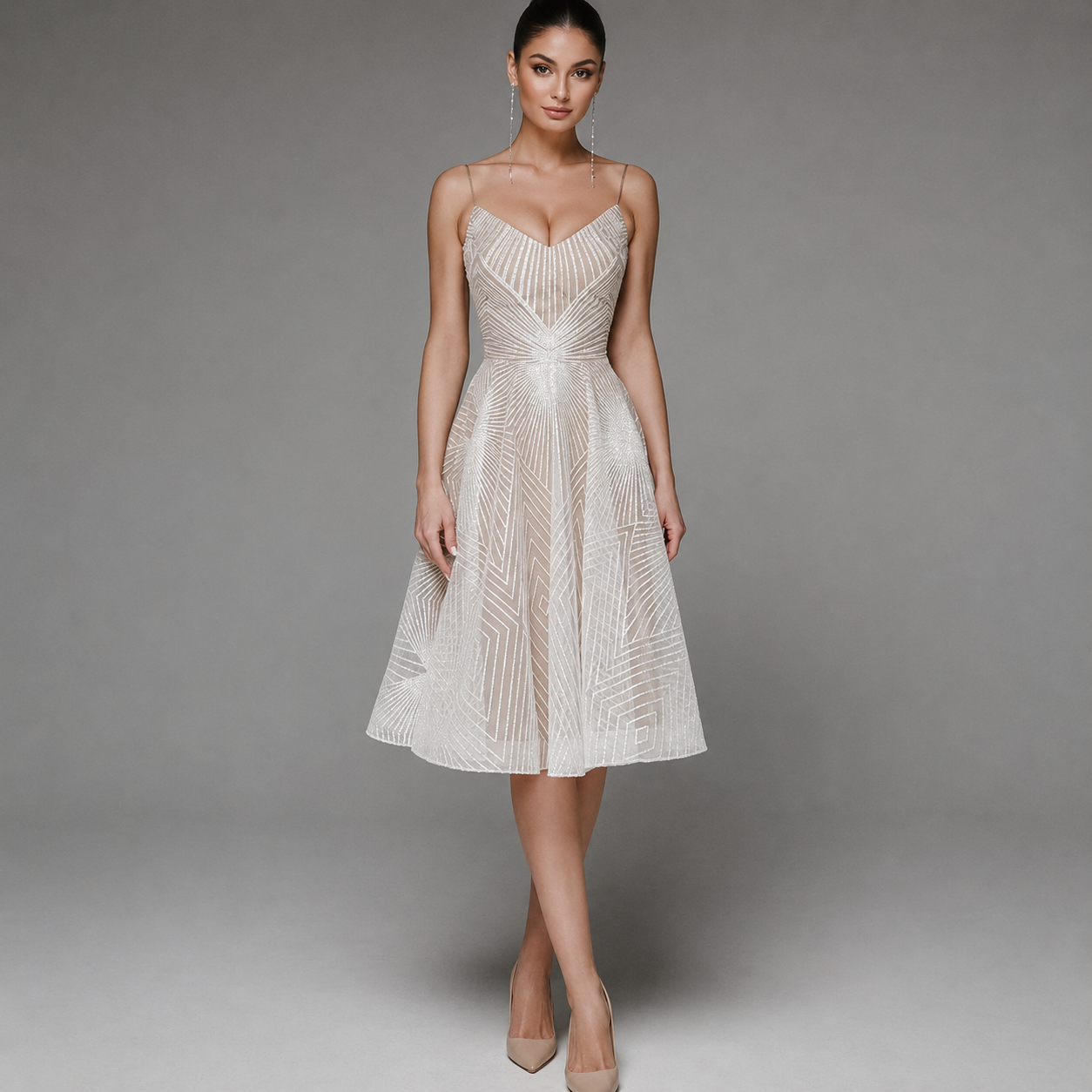 Woman wearing a white strapless dress with intricate detailing on a gray background