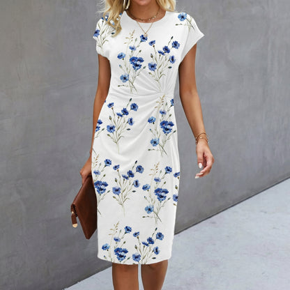 Woman wearing a white dress with blue floral pattern against a gray background