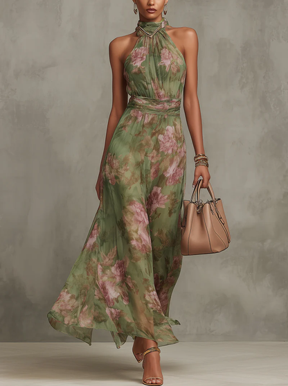 Woman wearing a green floral dress holding a beige handbag against a gray background