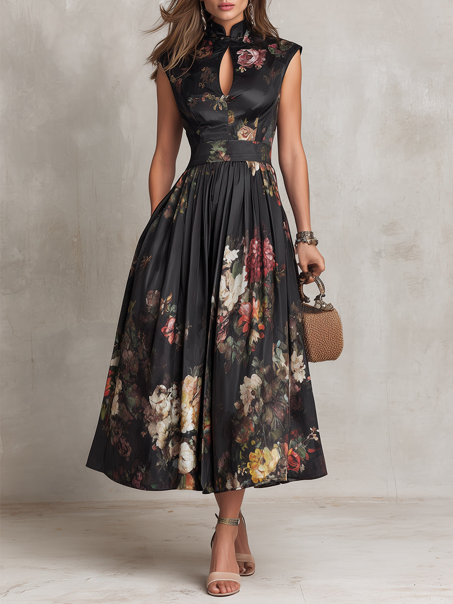 Woman wearing a black floral dress against a plain background