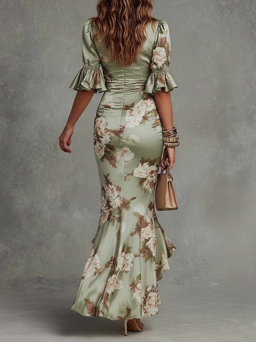 Woman wearing a floral dress with ruffled sleeves against a gray background