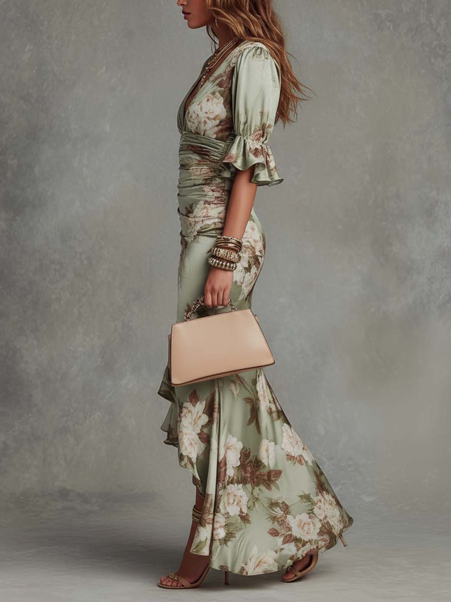 Woman in a floral dress holding a beige handbag against a gray background