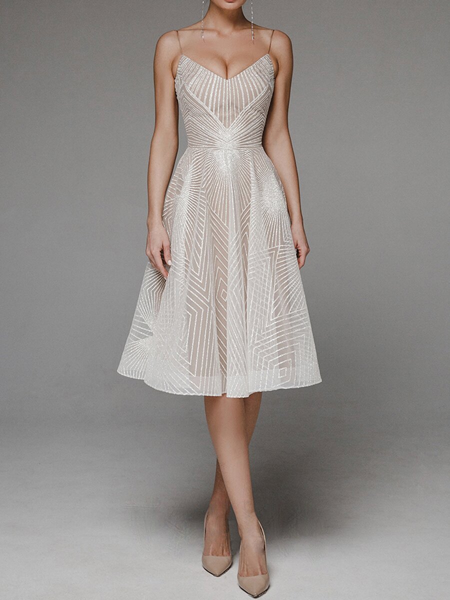 Beige dress with intricate patterns on a plain background