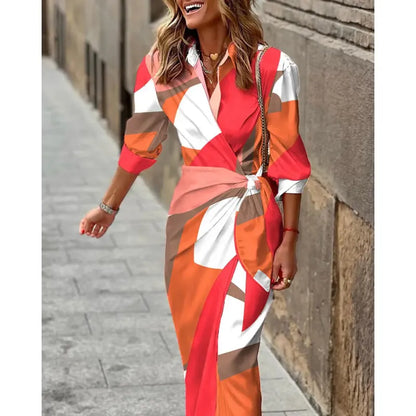 Woman wearing a colorful dress with geometric pattern walking on a street.