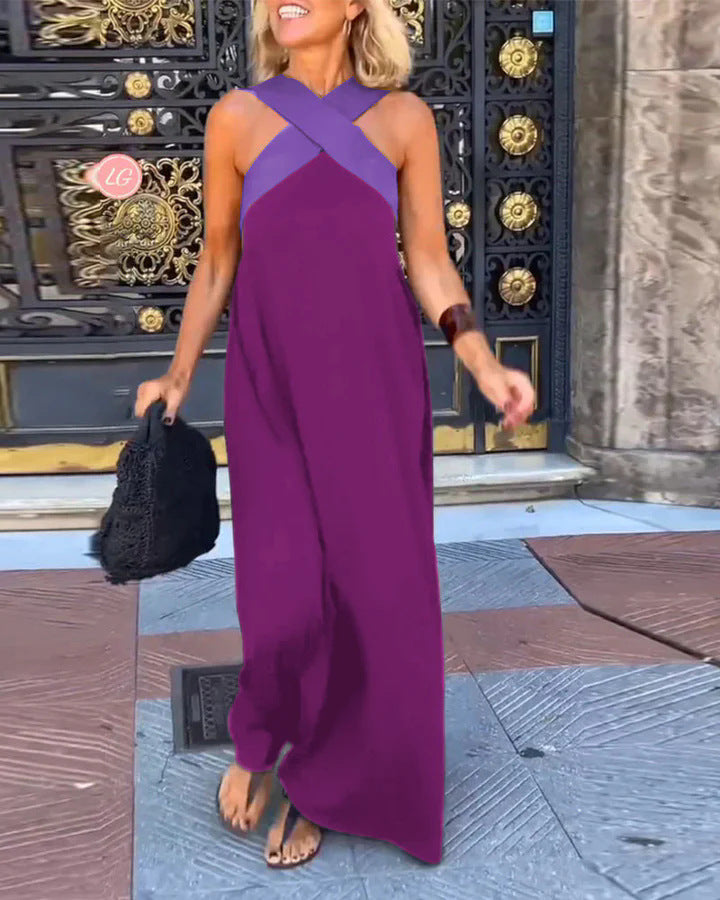 Woman in a purple dress standing in front of an ornate door.
