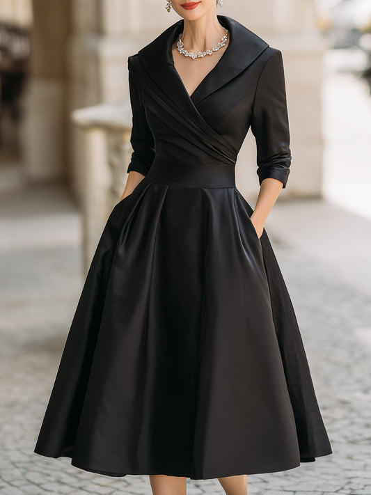Woman wearing a black dress with a collar in an urban setting