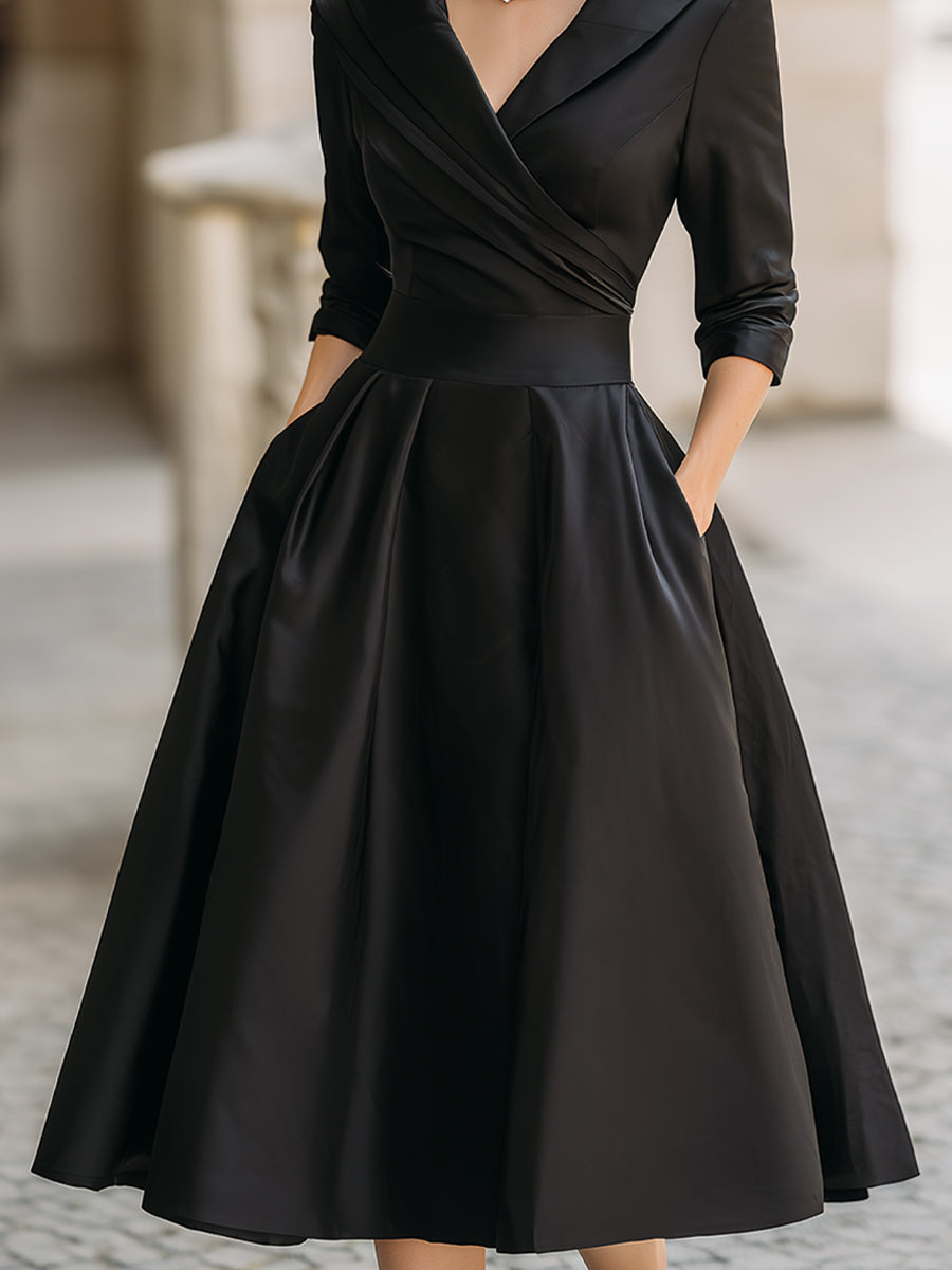 Black dress with long sleeves on a blurred background