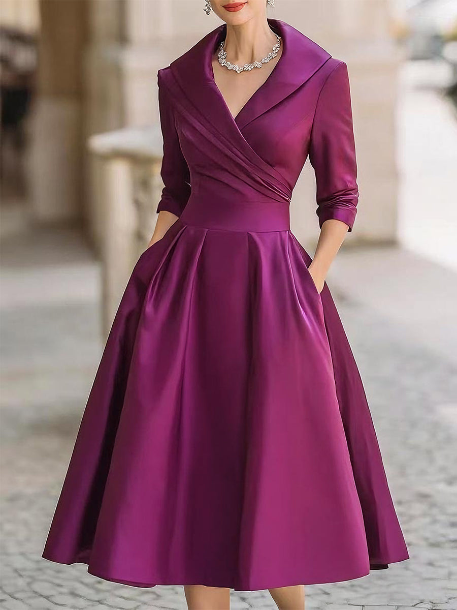 Purple dress worn by a person on a blurred street background