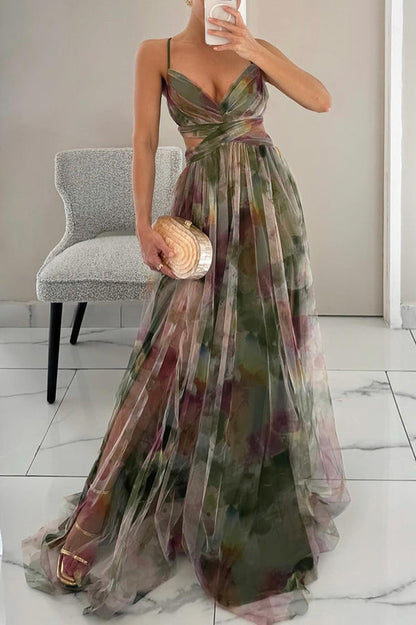 Woman wearing a floral dress holding a bouquet indoors.
