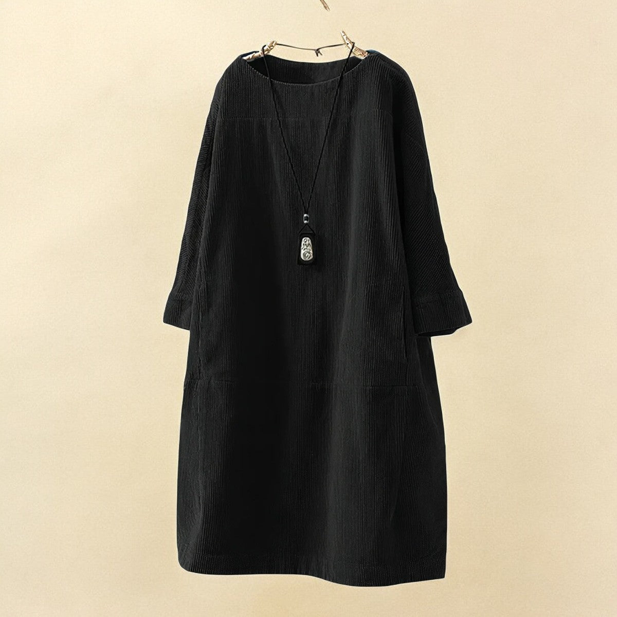 Black dress on a beige background