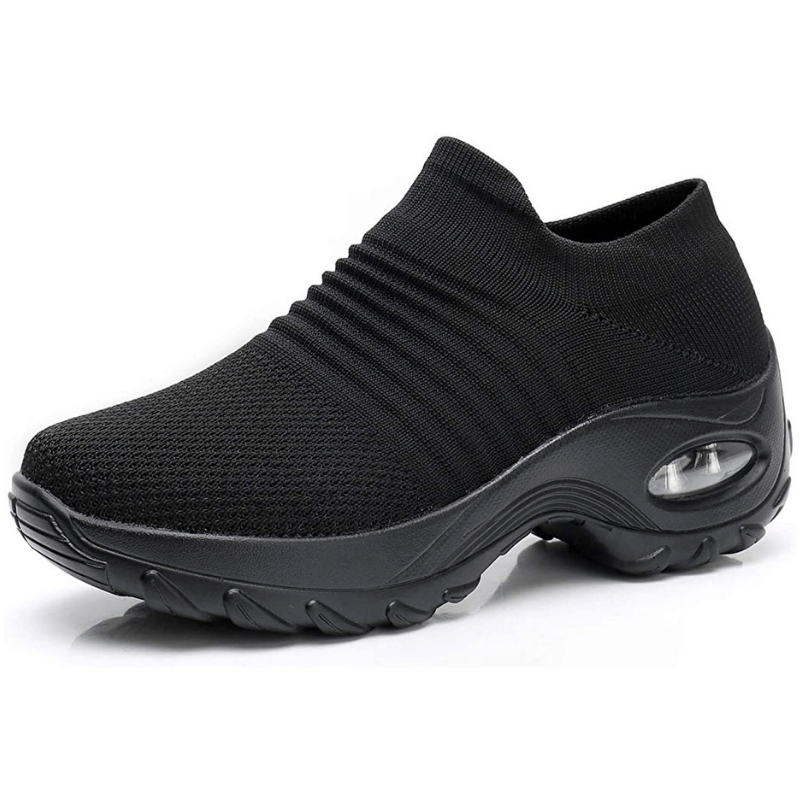 Black slip-on sneaker with a thick sole on a white background