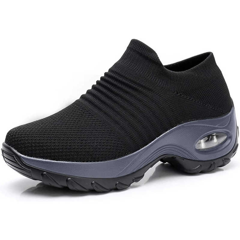 Black slip-on sneaker with a gray sole on a white background