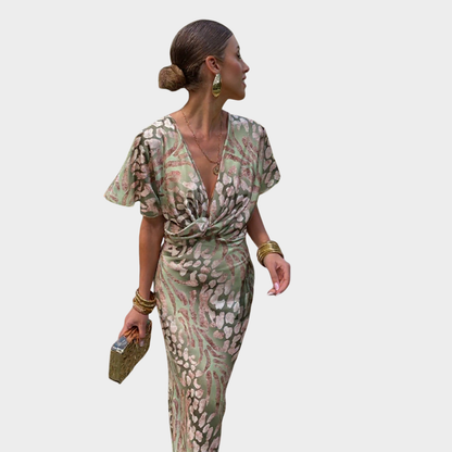 Woman wearing a patterned dress on a plain background