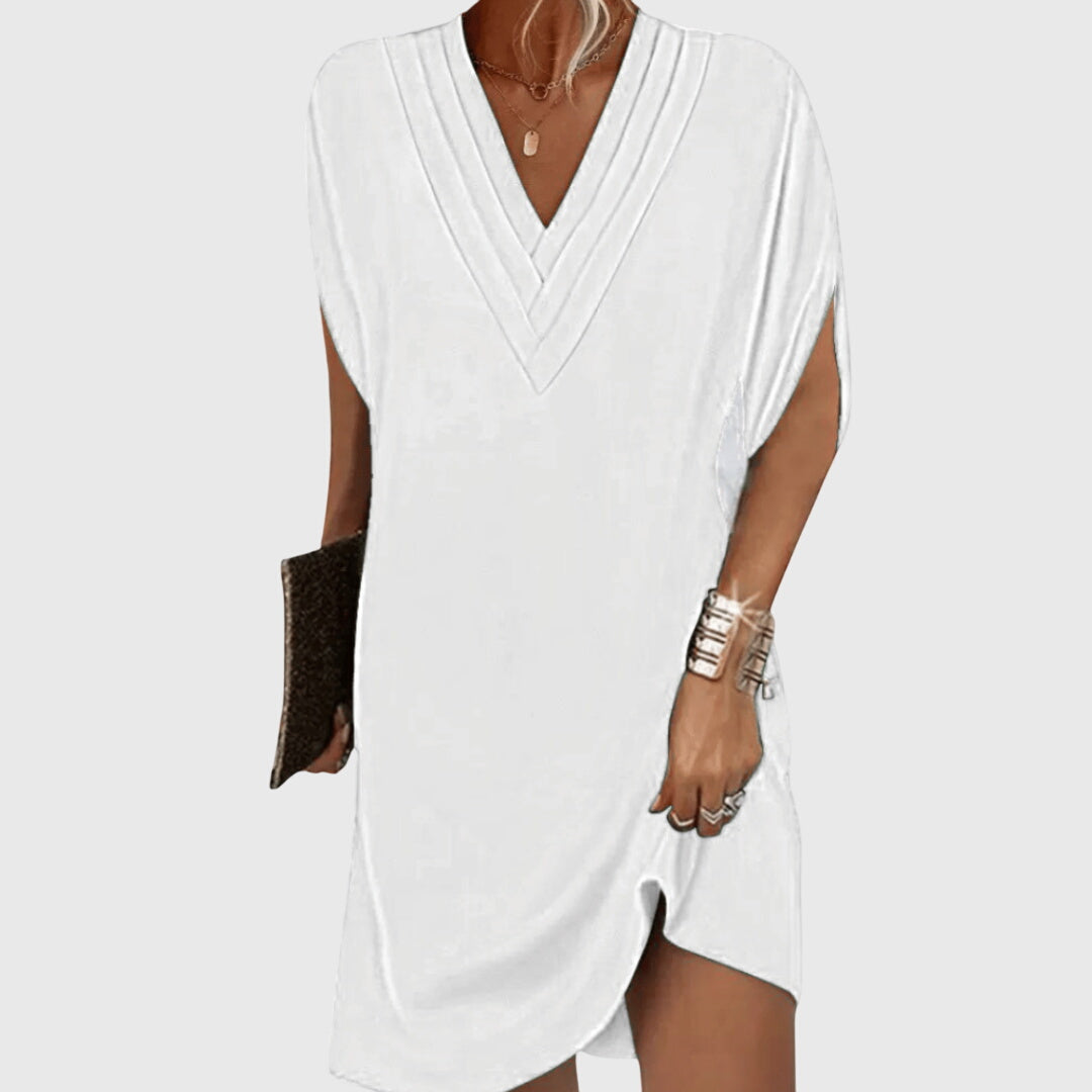White sleeveless dress worn by a person on a white background