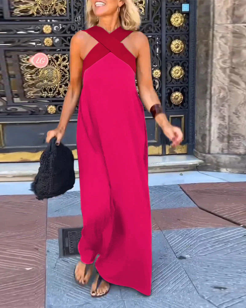 Woman in a red dress standing in front of ornate doors.