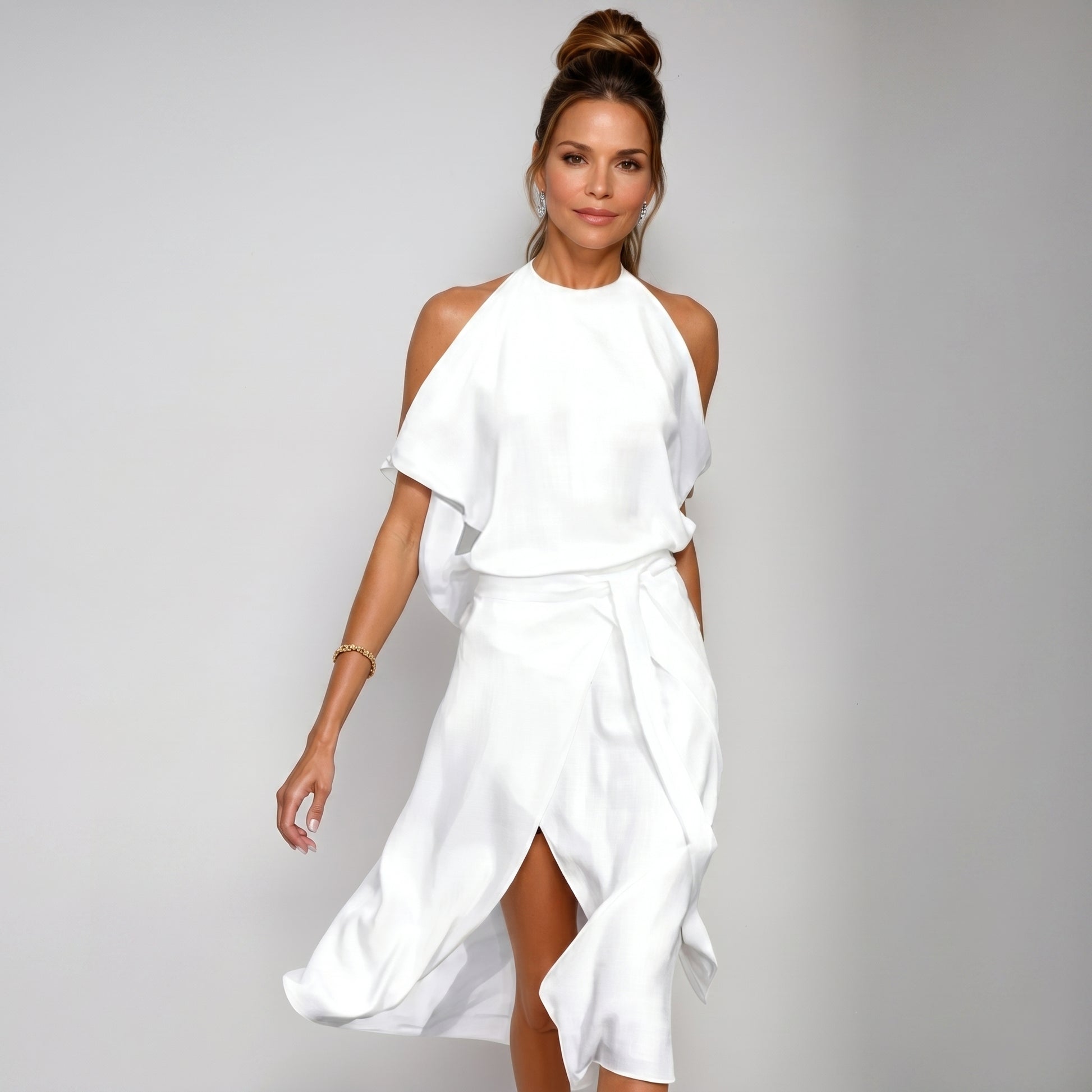 Woman wearing a white dress against a gray background