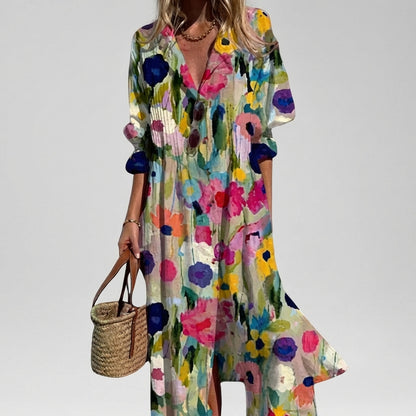 Woman wearing a colorful floral dress holding a straw bag on a plain background