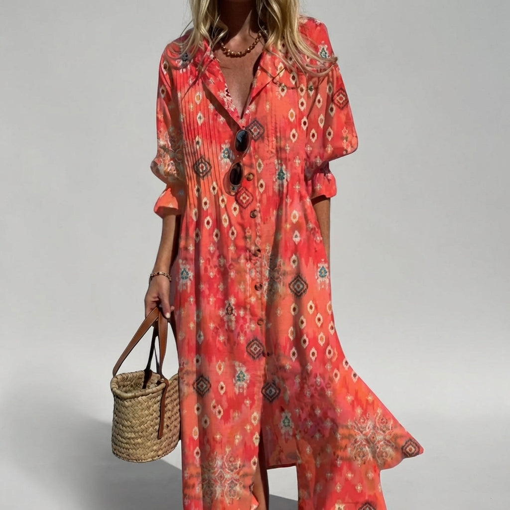 Woman wearing a red patterned dress holding a straw bag on a gray background