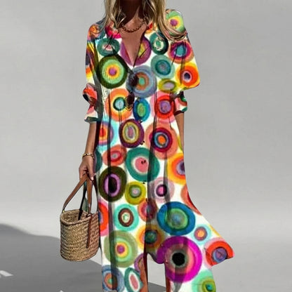 Woman wearing a colorful circular patterned dress on a gray background