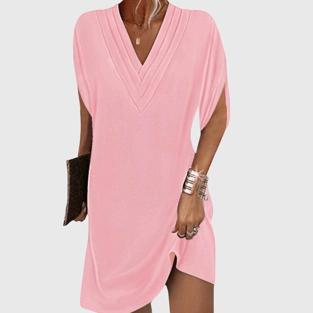 Pink dress worn by a person on a white background