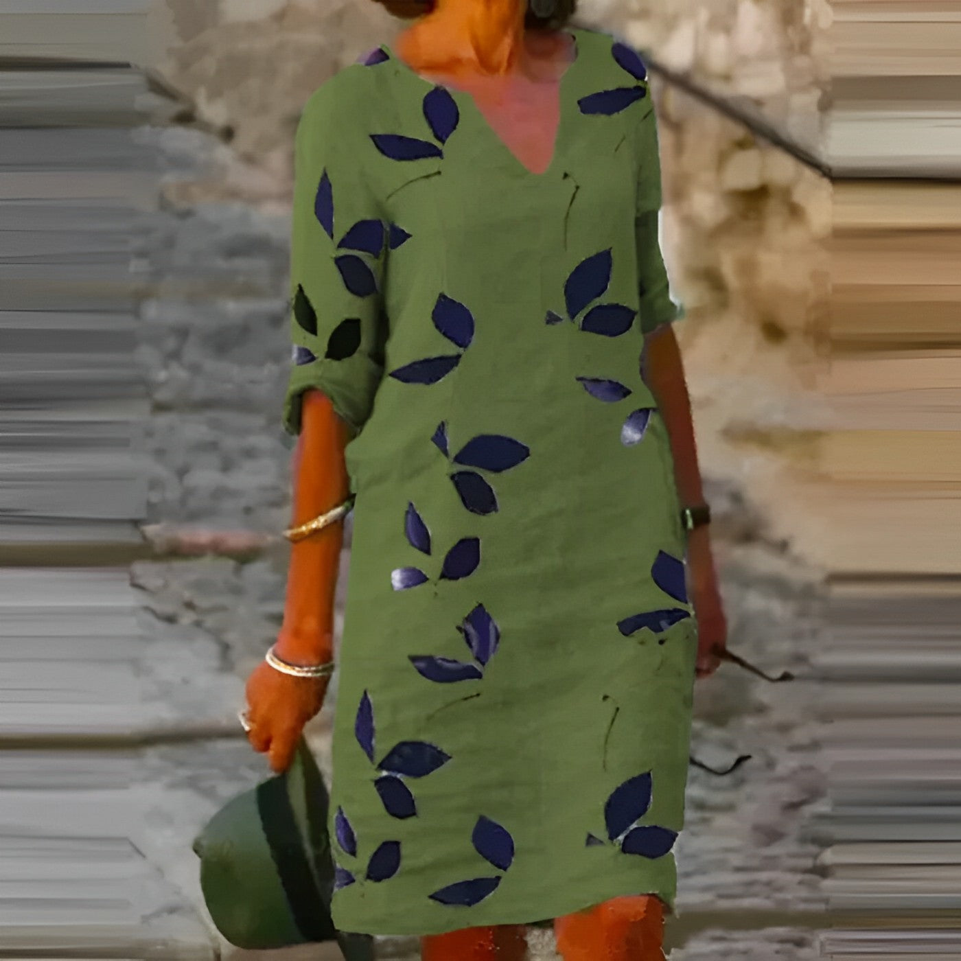 Green dress with leaf pattern worn by a person, blurred background