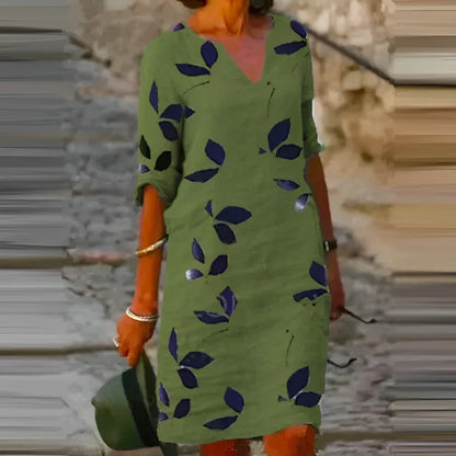 Green dress with leaf pattern worn by a person, blurred background
