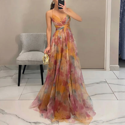 Woman in a colorful floral dress taking a mirror selfie in a room.