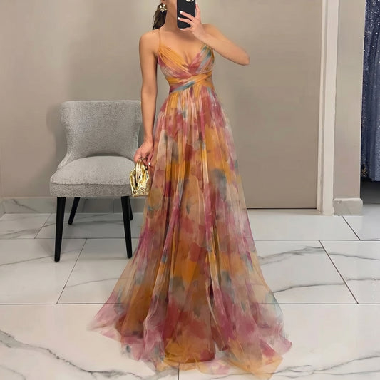Woman in a colorful floral dress taking a mirror selfie in a room.
