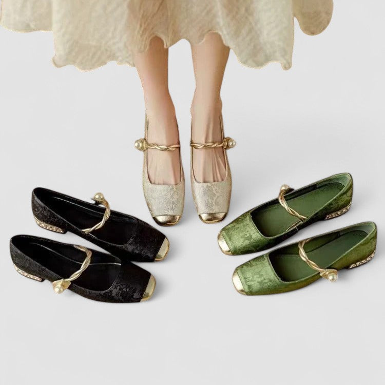 Pair of gold shoes worn by a person, with black and green shoes displayed in front on a light gray background.