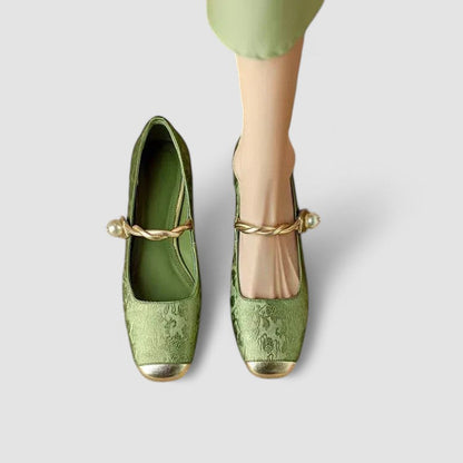 Green shoes with gold accents on a white background