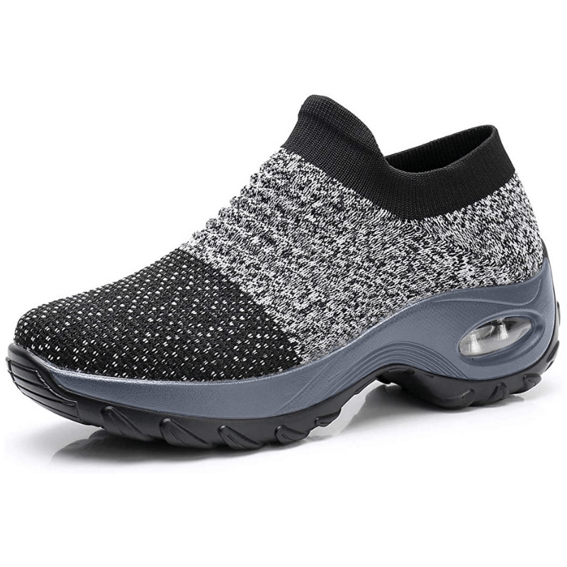 Black and gray slip-on shoe with a sole on a white background