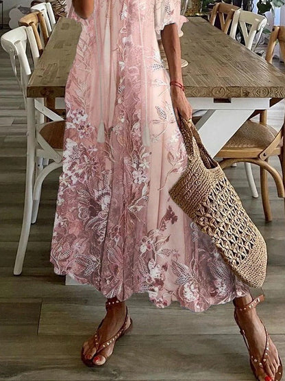 Person wearing a pink floral dress holding a woven bag in a dining area.
