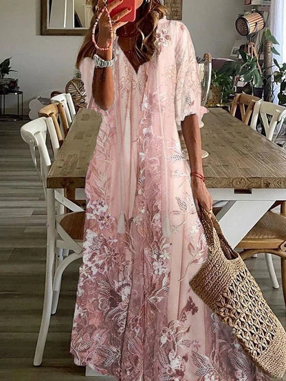 Woman in a pink floral dress holding a woven bag in a dining room.