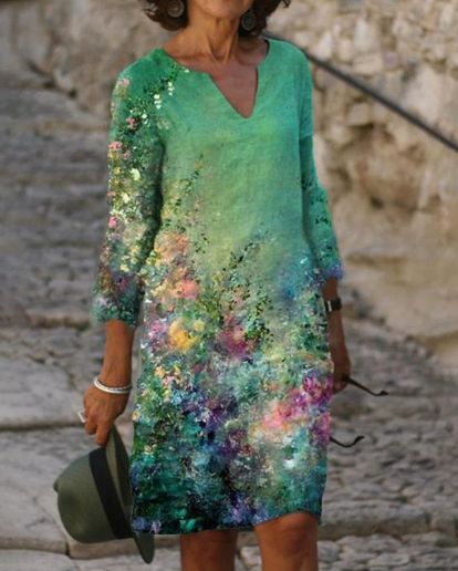 Woman wearing a colorful dress with sequins against a stone wall background