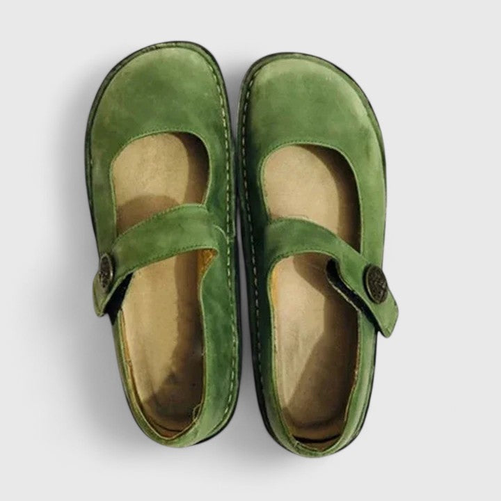 Pair of green shoes on a light gray background