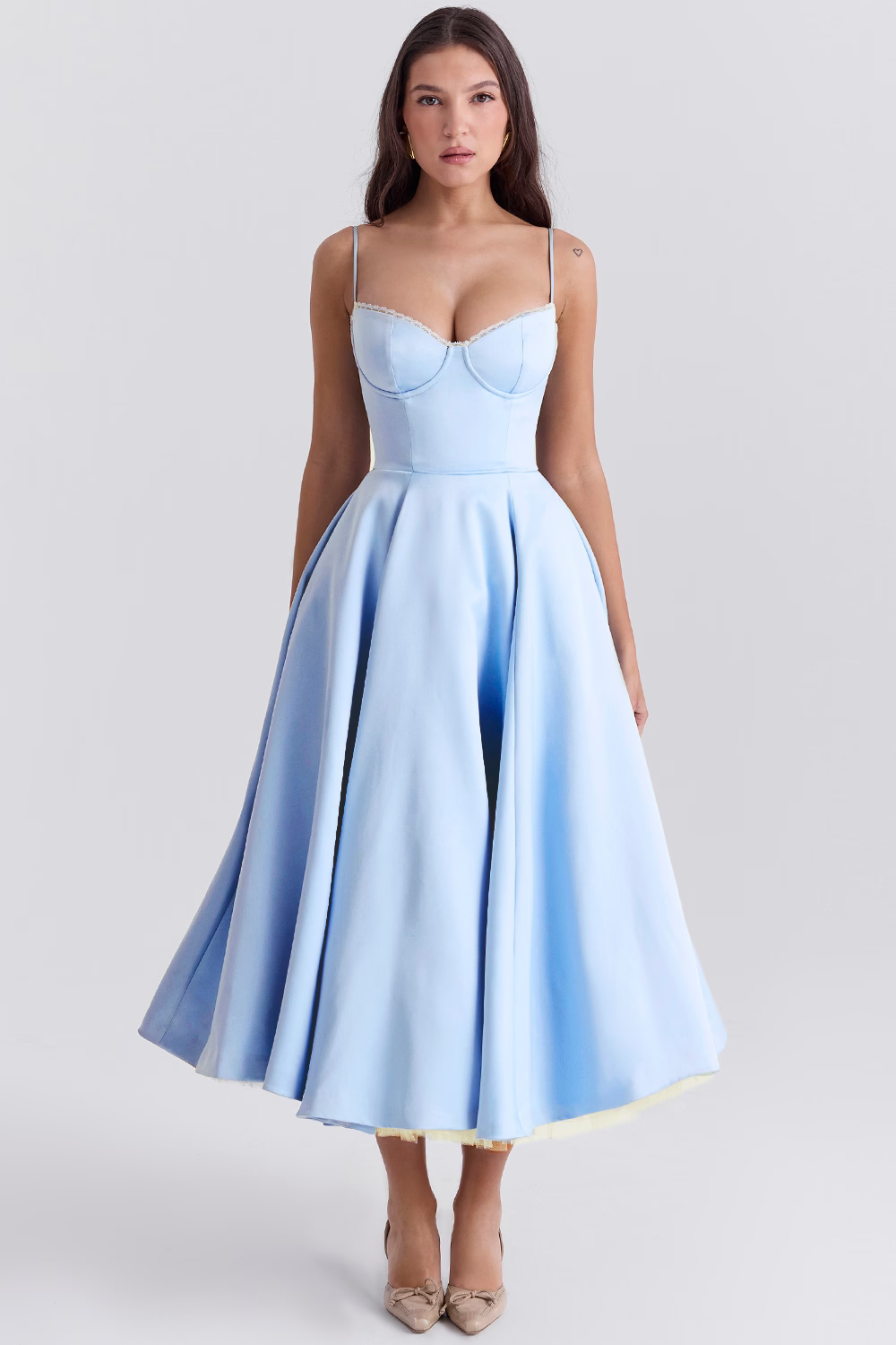 Woman wearing a light blue dress with a gradient effect on a white background