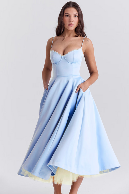 Woman wearing a light blue dress with a white background