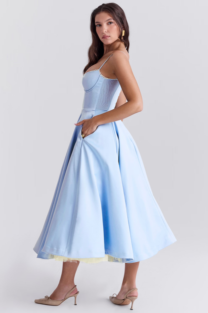 Woman wearing a light blue dress on a white background