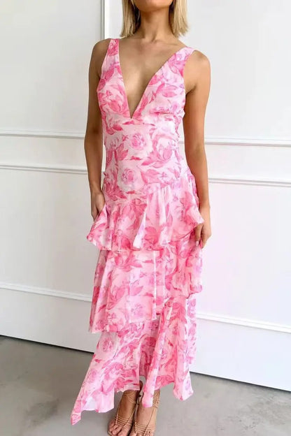 Woman wearing a pink floral dress against a white background