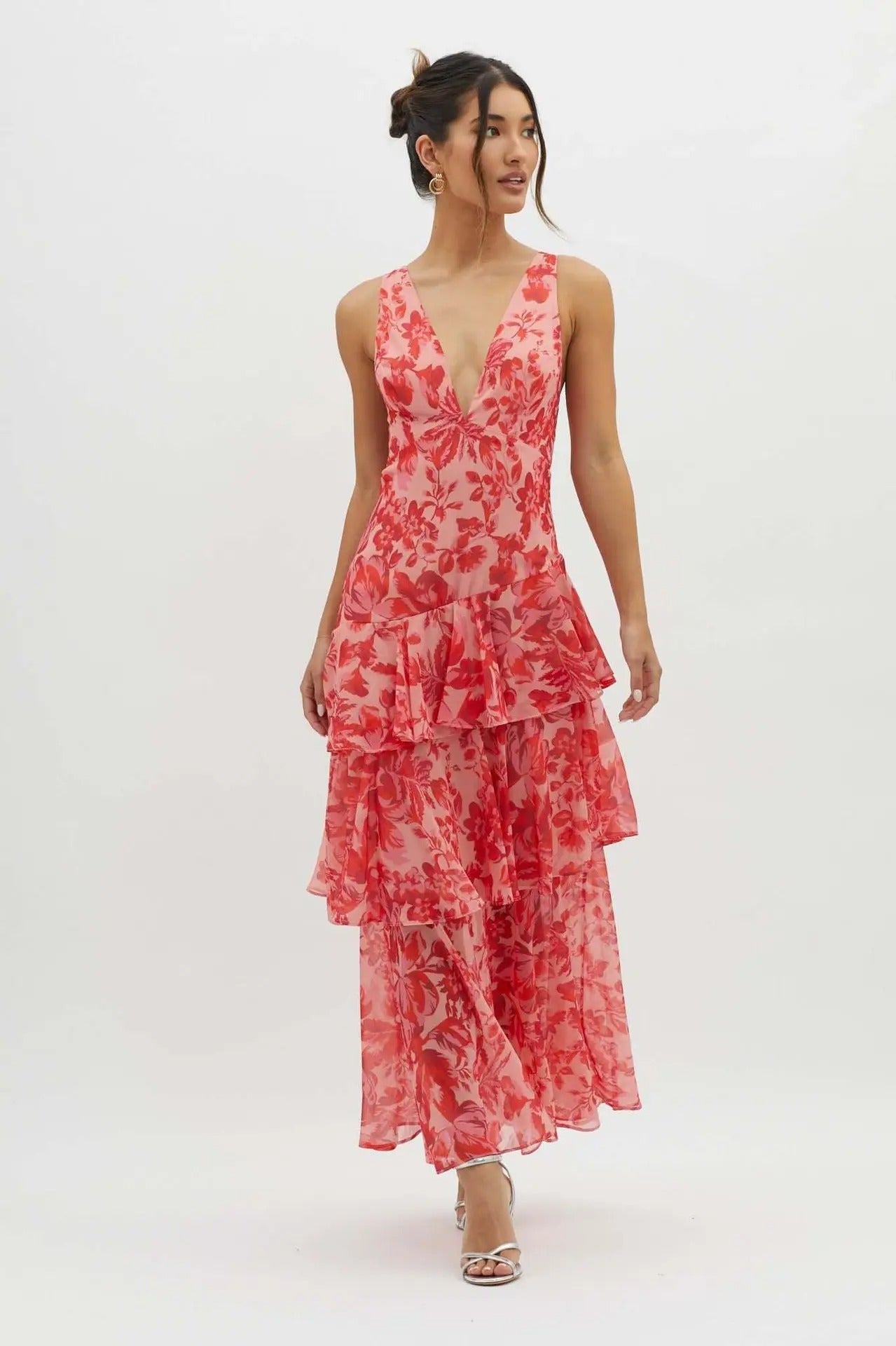 Woman wearing a red floral dress on a white background