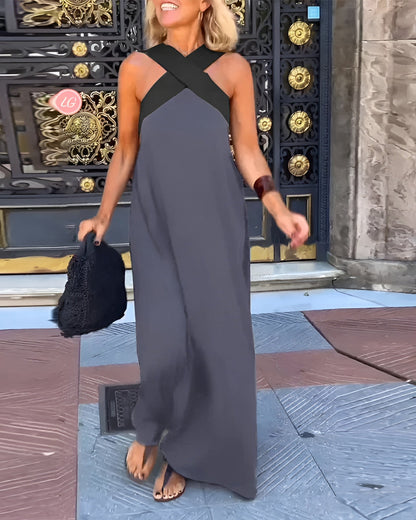 Woman in a long dark dress standing in front of an ornate door.