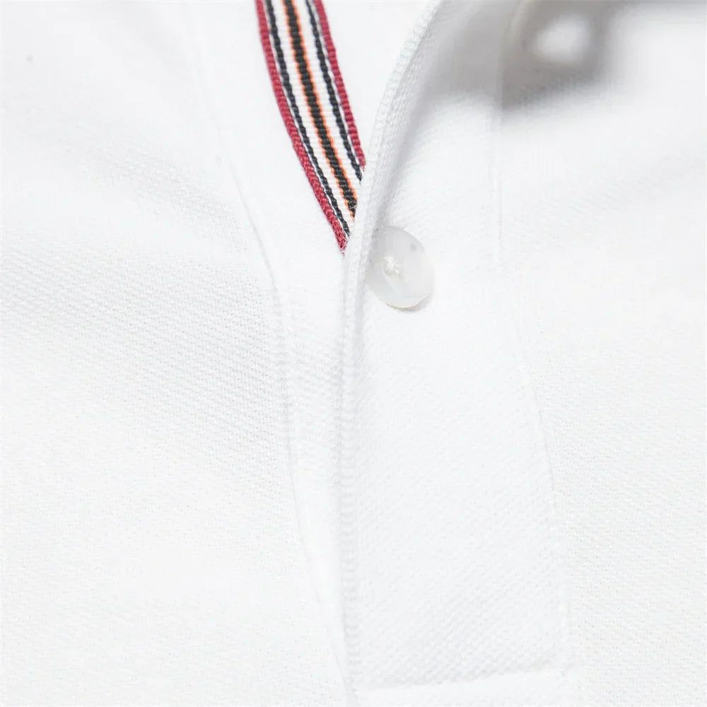 Close-up of a white polo shirt with a striped collar detail on a white background