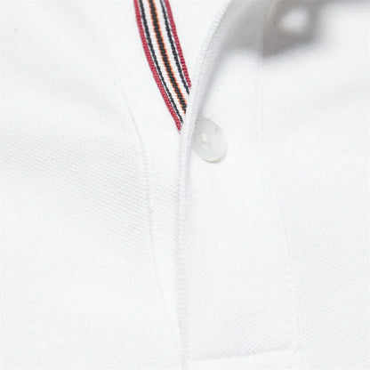 Close-up of a white polo shirt with a striped collar detail on a white background